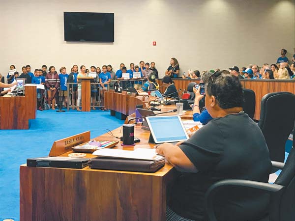 Maui County Council Member Tasha Kama (far right) and fellow council members look on as students from Lahaina Intermediate’s Hawaiian language immersion program prepare to sing during a meeting of the Governance, Ethics and Transparency Committee on Tuesday morning. Testifiers of all ages filled the Council Chambers to discuss the county pulling back a case from the U.S. Supreme Court involving injection wells at the Lahaina Wastewater Reclamation Facility. The Maui News/MELISSA TANJI photo