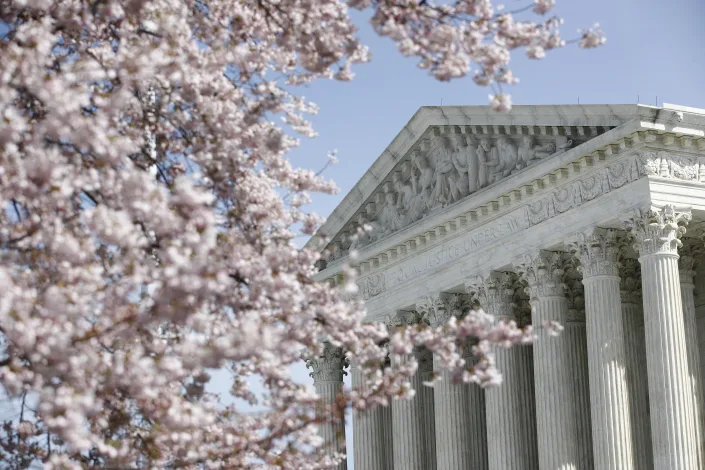 YAHOO FILE - In this March 16, 2020, file photo, a tree blooms outside the Supreme Court in Washington. The Supreme Court ruled Thursday, April 23, that sewage plants and other industries cannot avoid environmental requirements under landmark clean-water protections when they send dirty water on an indirect route to rivers, oceans and other navigable waterways. (AP Photo/Patrick Semansky, File)